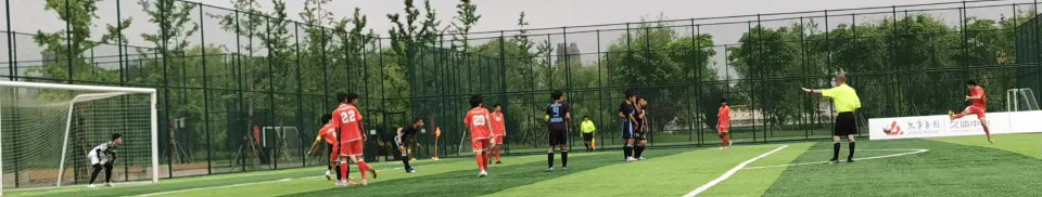 Our team in orange attacking during the match on an artificial pitch